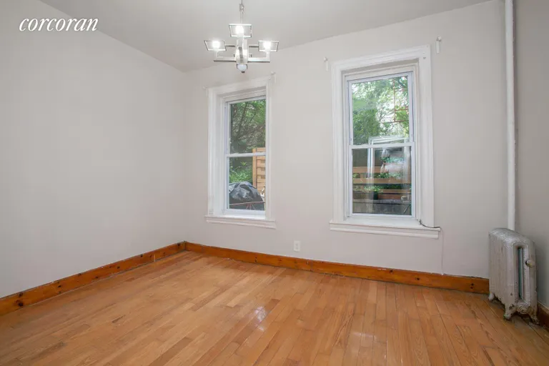 New York City Real Estate | View 489 Montgomery Street, 1-R | Bedroom with view of The garden | View 2