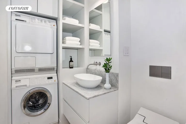 New York City Real Estate | View 111 Wooster Street, 5C | Bathroom with washer and dryer | View 6