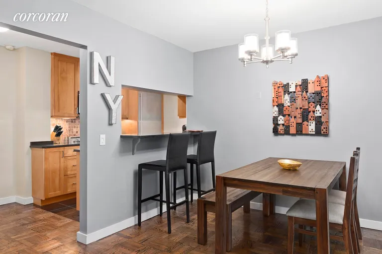 New York City Real Estate | View 235 East 57th Street, 2E | Dining area w/ open kitchen | View 3