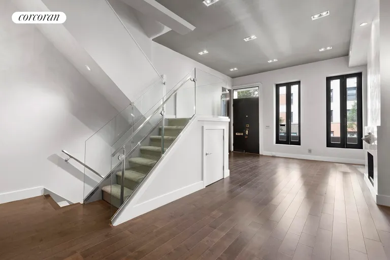 New York City Real Estate | View 310 East 69th Street | Main-level living area and staircase. | View 4