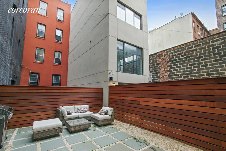 New York City Real Estate | View 43 Dean Street | Backyard with stone pavers and Ipe fencing | View 19
