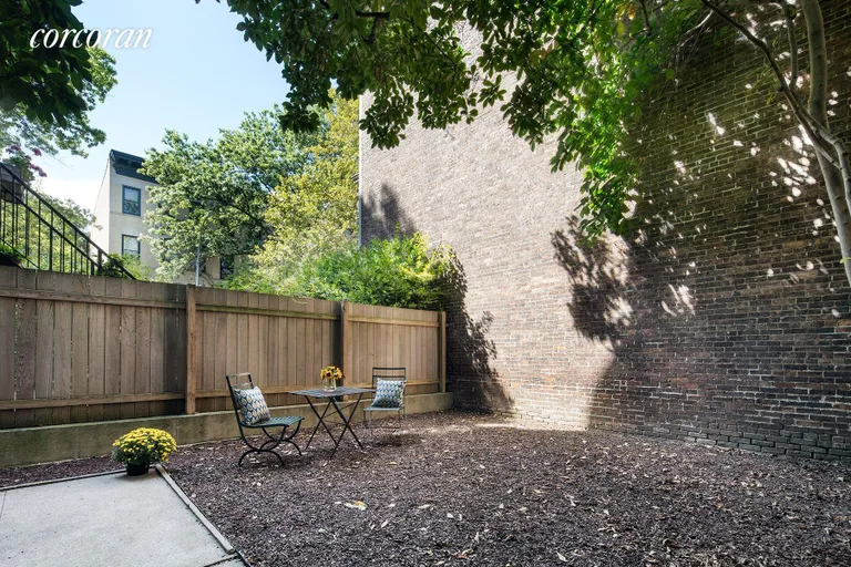 New York City Real Estate | View 106 Prospect Park West, 1 | Fenced yard with patio and lovely brick wall | View 12