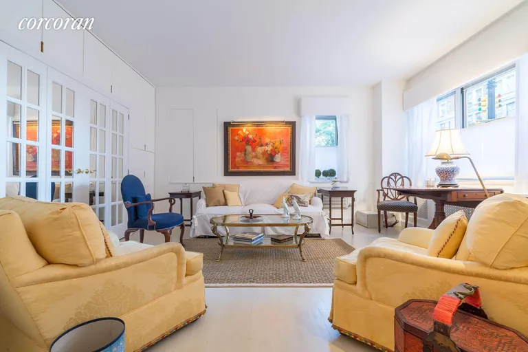 New York City Real Estate | View 20 Sutton Place South, 1C | Bright Living Room w/custom built-in speaker+bar | View 2