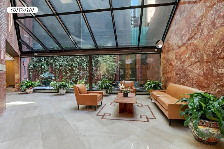 New York City Real Estate | View 303 East 43rd Street, 20C | Furnished Lobby with Outdoor Garden | View 5