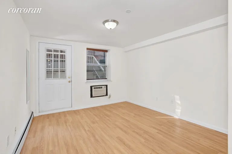 New York City Real Estate | View 104 Clifton Place, A1 | Bedroom #2 with door leading out to backyard. | View 11