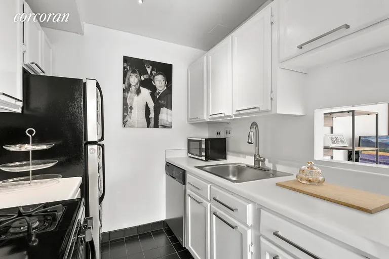 New York City Real Estate | View 77 Bleecker Street, 1011 | Clean White Kitchen w Pass Thru | View 3