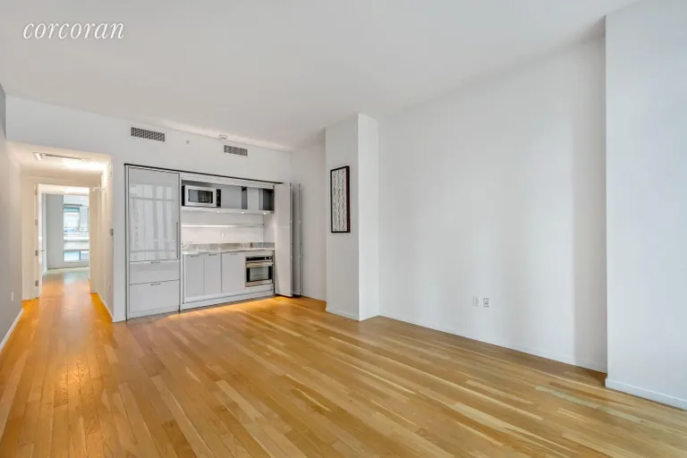 New York City Real Estate | View 18 West 48th Street, 15-E | Hideaway Pullman Kitchen with frosted glass doors | View 3