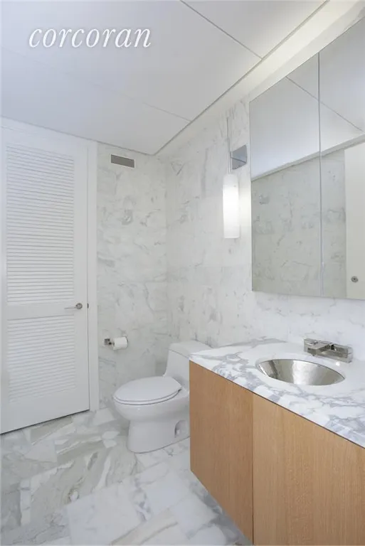 New York City Real Estate | View 18 West 48th Street, 15-E | Washer and Dryer in half bath laundry closet | View 8