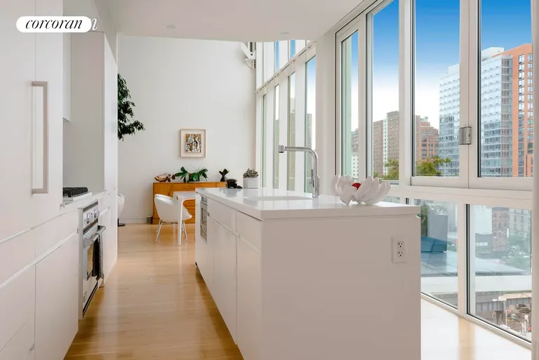 New York City Real Estate | View 524 West 19th Street, PH | Kitchen with south views and balcony | View 6