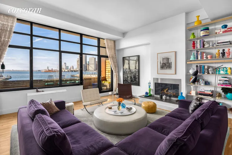 New York City Real Estate | View 360 Furman Street, 206 | Water-facing living room with gas fireplace | View 2