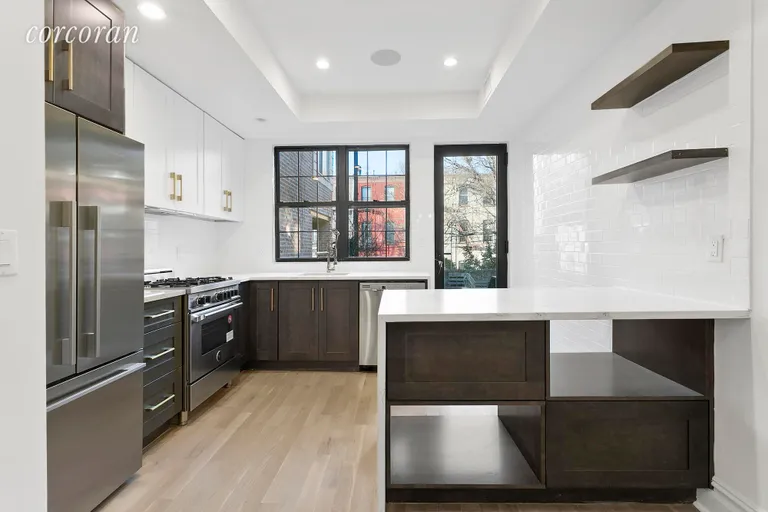 New York City Real Estate | View 89 Maujer Street | Top of the line kitchen leading to rear deck | View 4