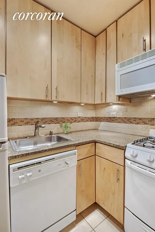 New York City Real Estate | View 399 East 72Nd Street, 9C | Kitchen with full-sized dishwasher and granite | View 4