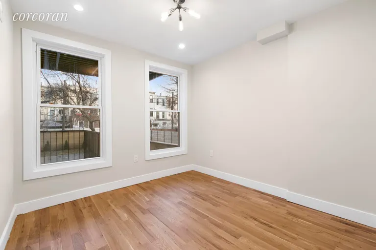 New York City Real Estate | View 666 Chauncey Street, 1 | Spacious bedroom with stylish lighting fixtures | View 5