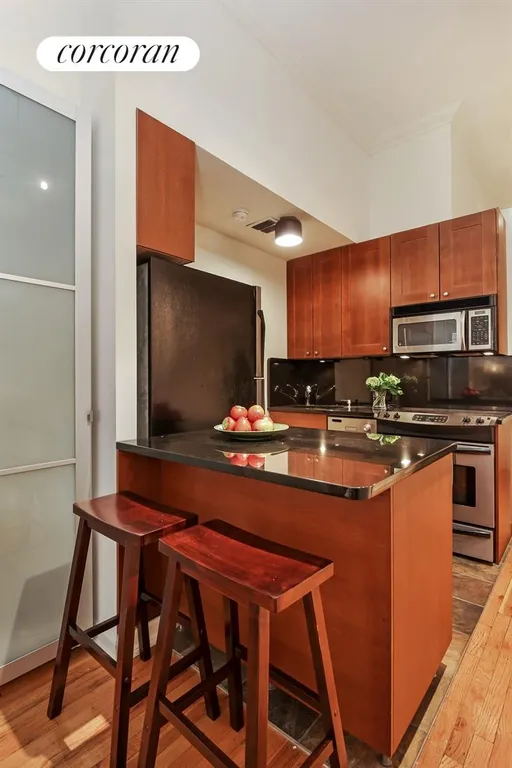 New York City Real Estate | View 23 Waverly Place, 3K | Kitchen with Counter & Stools | View 8