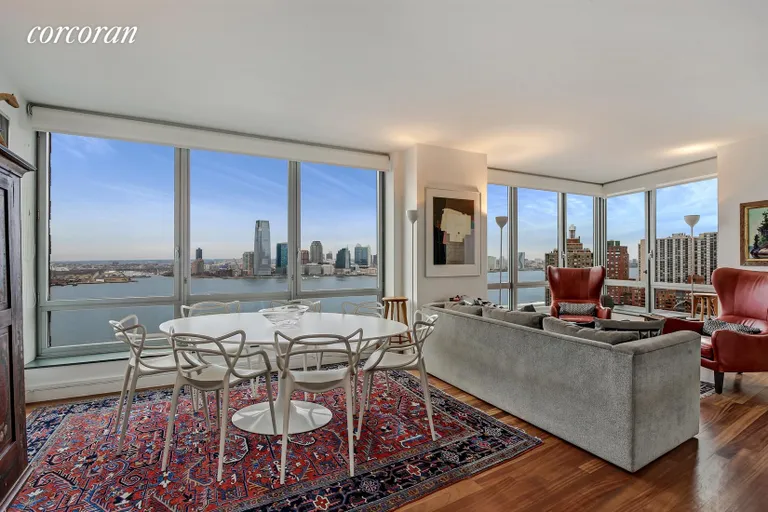 New York City Real Estate | View 30 West Street, 23A | Living Room with Direct Hudson River Views | View 3