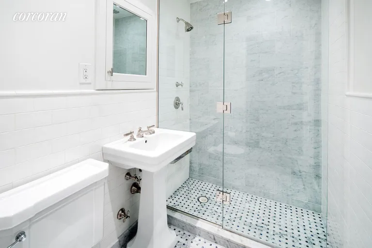 New York City Real Estate | View 23 East 10th Street, 412 | Renovated master bath with tiled shower stall | View 7