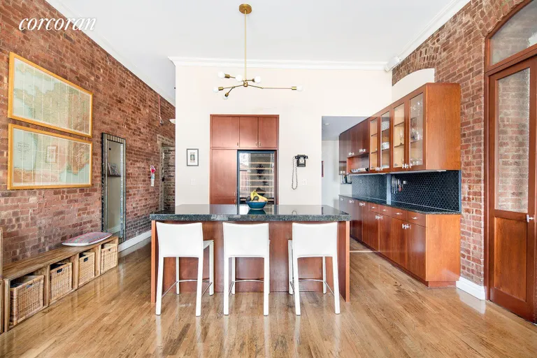 New York City Real Estate | View 23 East 10th Street, 412 | Dining area with 6-seater island | View 2
