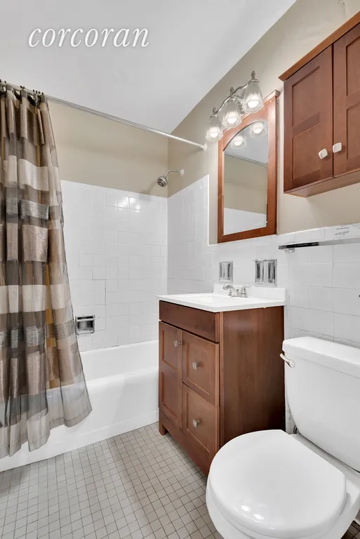 New York City Real Estate | View 392 Central Park West, 12J | Luxurious Bathroom with Wood Cabinets | View 6