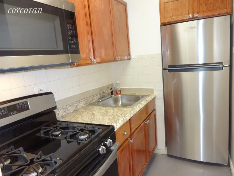 New York City Real Estate | View 2104 Holland Avenue, 5D | Stove/oven, Microwave and Refrigerator | View 5