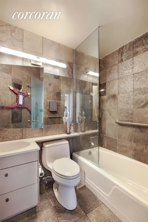 New York City Real Estate | View 20 East 9th Street, 3U | Bathroom with polished slate tiling | View 5