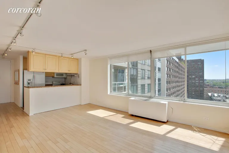 New York City Real Estate | View 404 East 79th Street, 11H | Living Room and Pass-through Kitchen | View 2