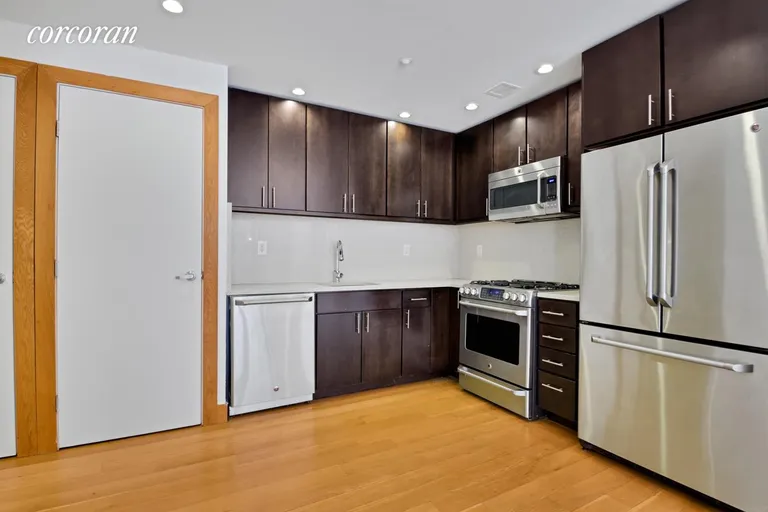 New York City Real Estate | View 152 East 118th Street, 2G | Stainless steel appliances and
Stacked Bosch W/D | View 7