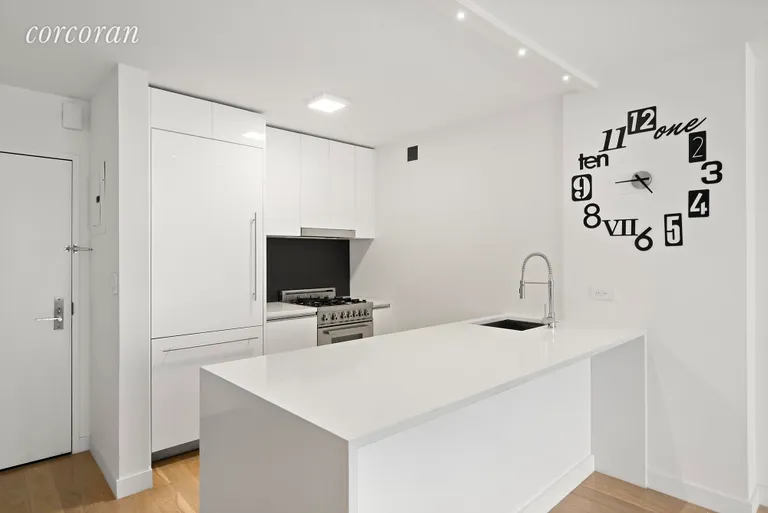New York City Real Estate | View 301 West 53rd Street, 17H | Sleek modern kitchen with paneled appliances | View 2