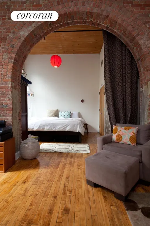 New York City Real Estate | View 138 Broadway, 2C | Exposed Brick Archway Leading to Bedroom | View 4