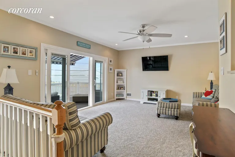 New York City Real Estate | View 562 Beach 132nd Street | Living Room with sliders out to a deck | View 2