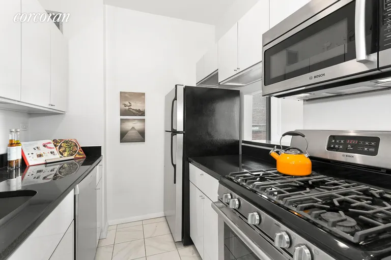 New York City Real Estate | View 77 Bleecker Street, 1215 | Renovated kitchen with modern lacquer cabinets. | View 4