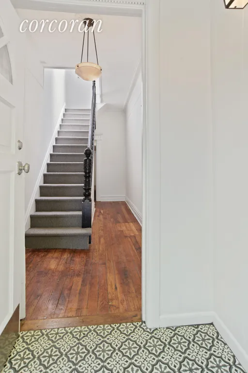 New York City Real Estate | View 295 East 7th Street | Welcoming entry foyer with rebuilt stairs | View 4