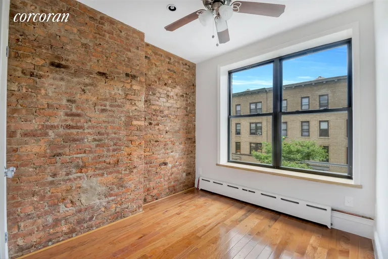 New York City Real Estate | View 61-31 Madison Street, 3R | bright bed room with exposed bricks | View 5
