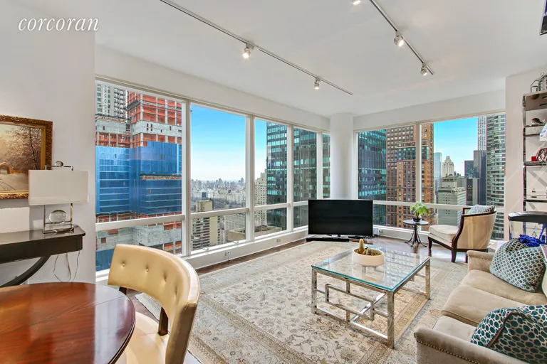 New York City Real Estate | View 230 West 56th Street, 52A | Corner Living Area w/ Central Park and City Views | View 2