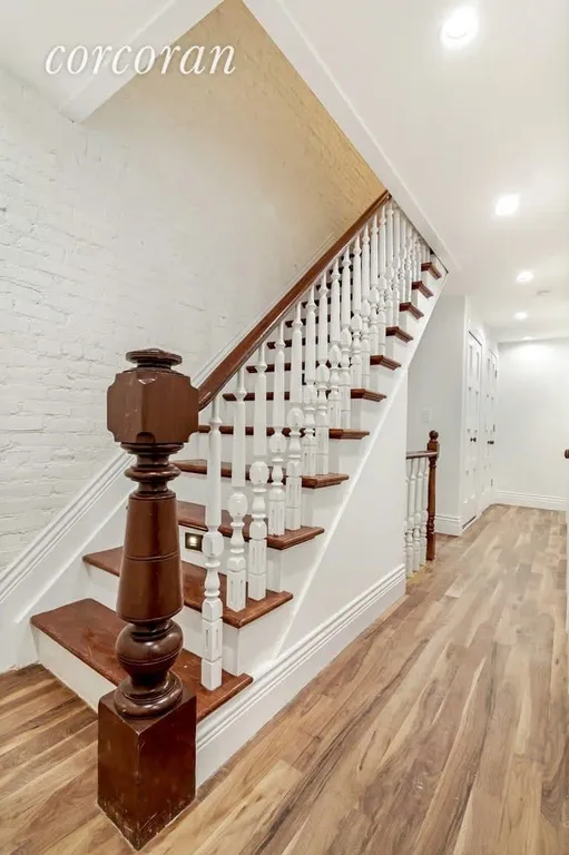 New York City Real Estate | View 282 Clifton Place, 1 | Hallway with Architectural Staircase | View 9