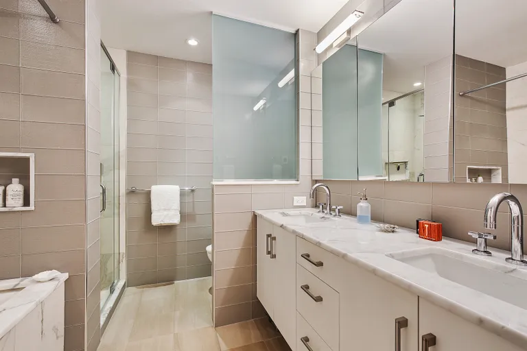 New York City Real Estate | View 201 East 80th Street, 10E | Expertly renovated master bathroom | View 6