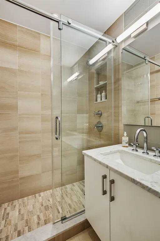 New York City Real Estate | View 201 East 80th Street, 10E | Pristine Second Full bathroom with Ann Sacks tiles | View 8