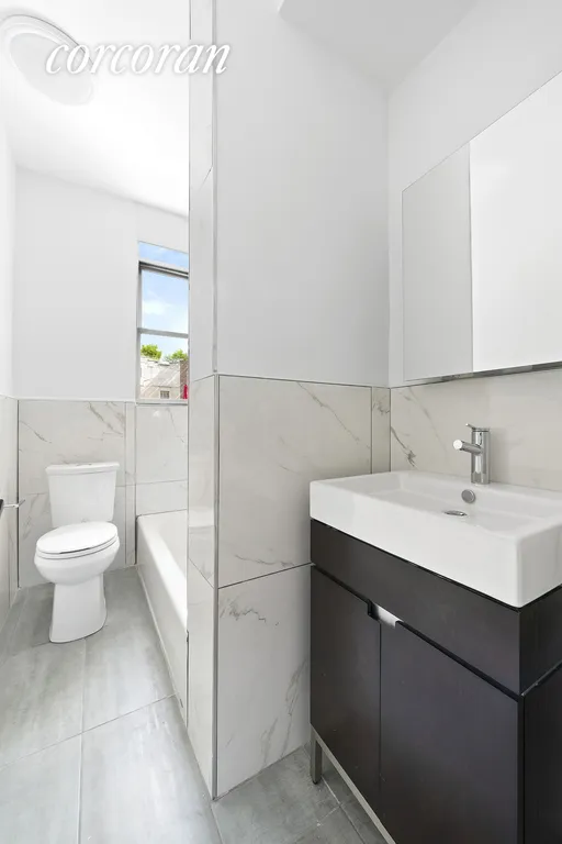 New York City Real Estate | View 59-11 Queens Boulevard, 1A | Polished windowed bathroom with stall shower | View 6
