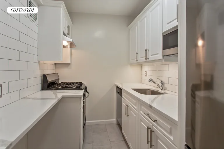 New York City Real Estate | View 385 East 16th Street, 2H | Crisp kitchen w/ dishwasher & breakfast counter | View 2