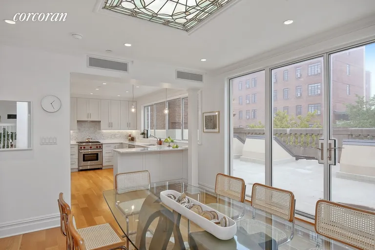New York City Real Estate | View 105 8th Avenue, PH | Kitchen and Dining with Sliding Doors to Terrace | View 5