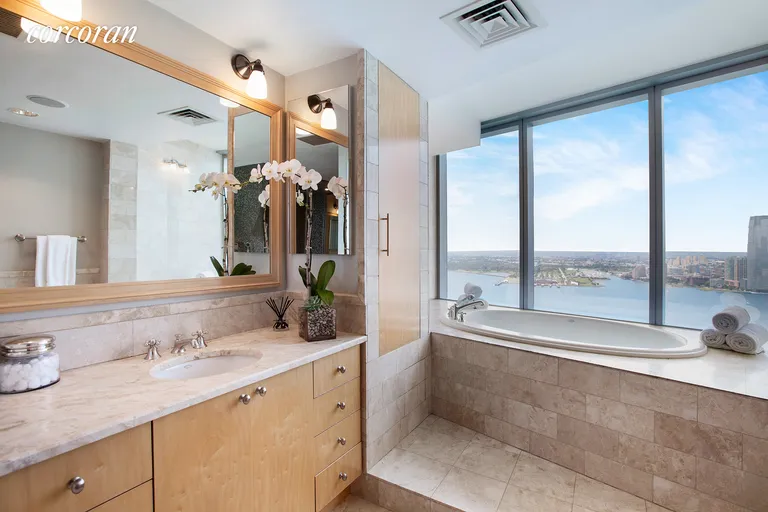 New York City Real Estate | View 10 West Street, PH2C | Master Bathroom with Direct Western River Views | View 7