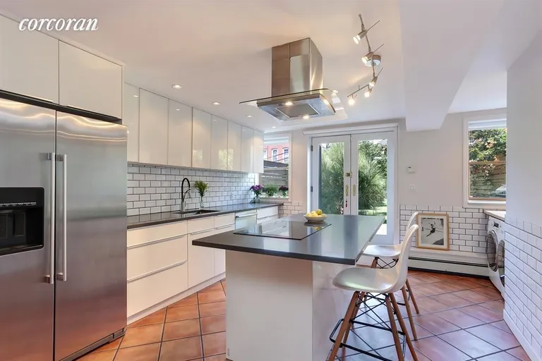 New York City Real Estate | View 451 37th Street | Renovated Kitchen Leading to Lush Private Garden | View 13