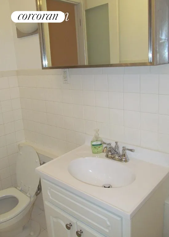 New York City Real Estate | View 135 West 16th Street, 17 | new sink, cabinet  & a toilet | View 9