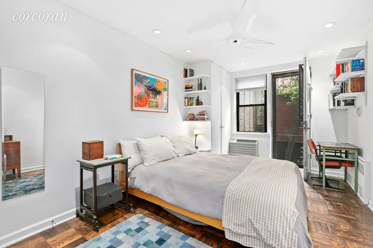 New York City Real Estate | View 250 West 15th Street, 2C | Tranquil and roomy bedroom
w garden entrance | View 6