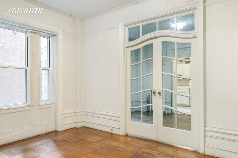 New York City Real Estate | View 440 Riverside Drive, 44 | Original doors dividing living room dining room | View 4