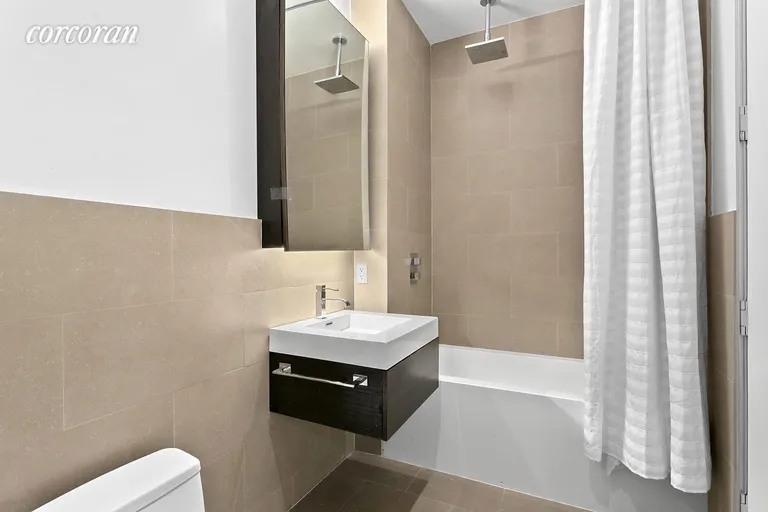 New York City Real Estate | View 140 West 22Nd Street, 2A | Beautifully renovated bathroom with washer/dryer | View 6