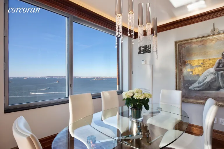New York City Real Estate | View 10 West Street, 27E | Dining Room with Direct Statue Views | View 3