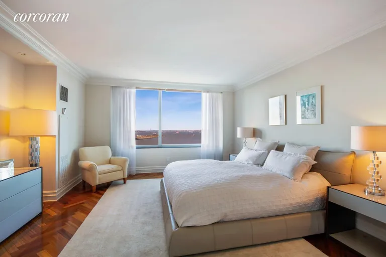 New York City Real Estate | View 10 West Street, 27E | Master Bedroom with Direct Harbor & Statue Views | View 8