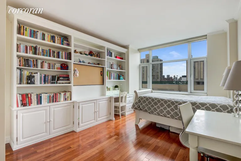 New York City Real Estate | View 404 East 76th Street, 20A | 2nd Bedroom with a wall of built-ins & west views | View 4
