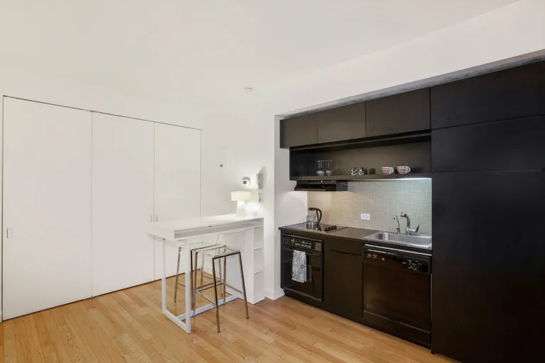 New York City Real Estate | View 56 Pine Street, 7E | Chic Custom Kitchenette with dishwasher | View 2