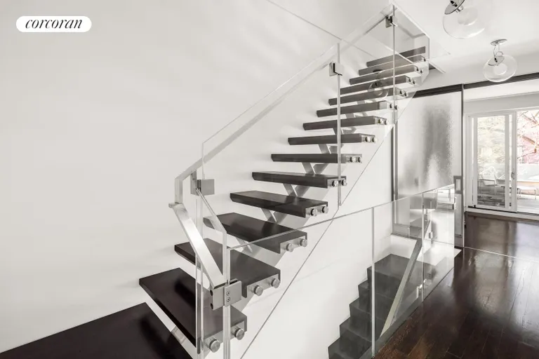 New York City Real Estate | View 16 Sidney Place | Cantilevered stairs ascend in elegance | View 10
